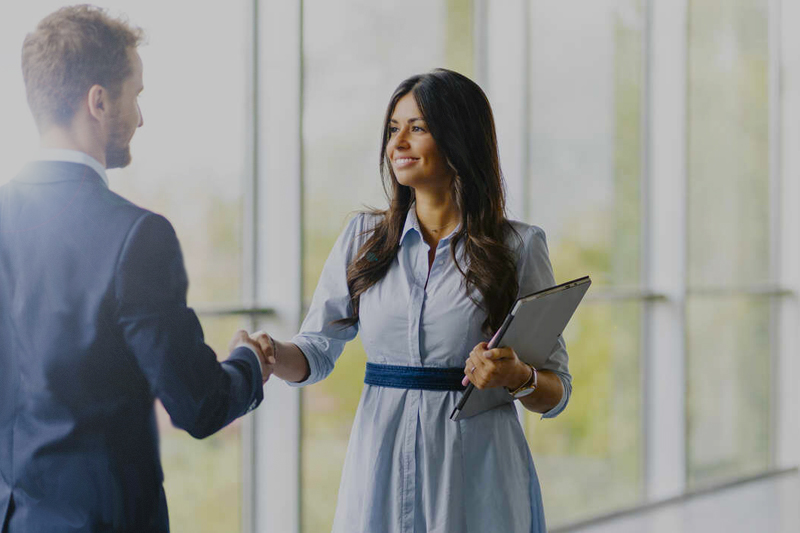 Two Business English students shaking hands