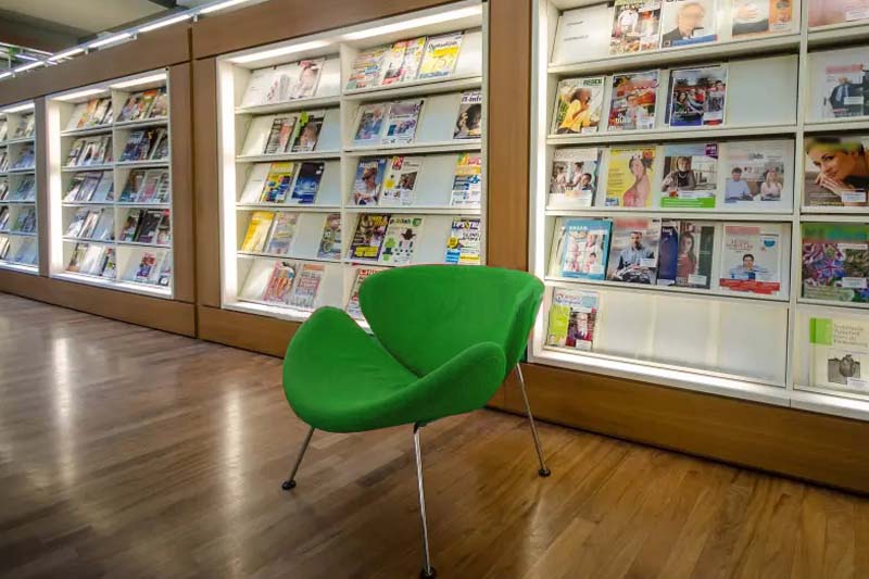 Modern comfortable library showing many magazines